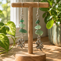 Aventurine clover earrings hanging on a stand