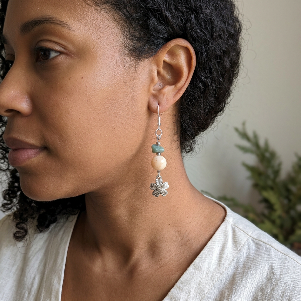 Curly-haired model wearing Moss and Stone Blossom earrings