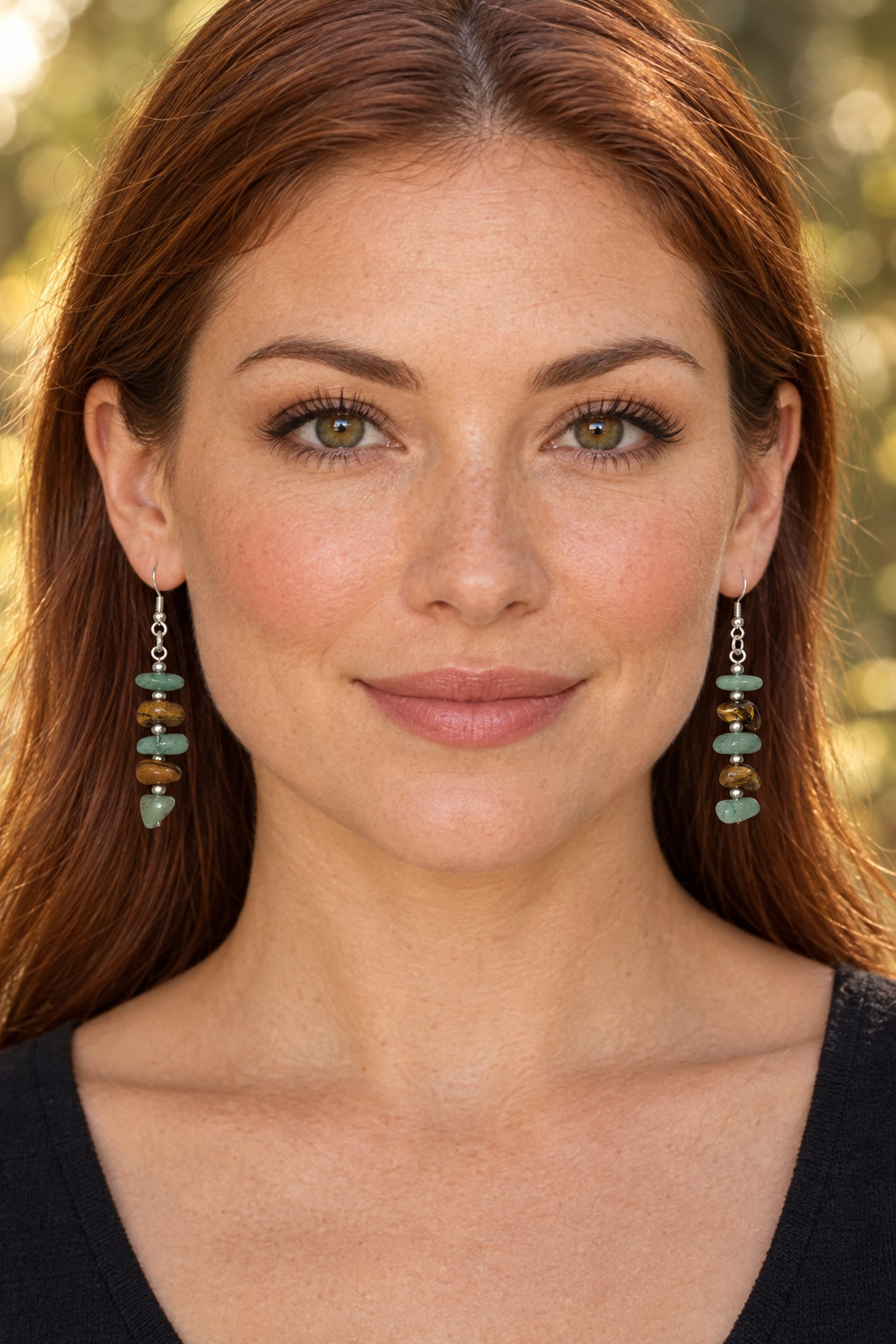 Second model wearing the green-and-brown earrings