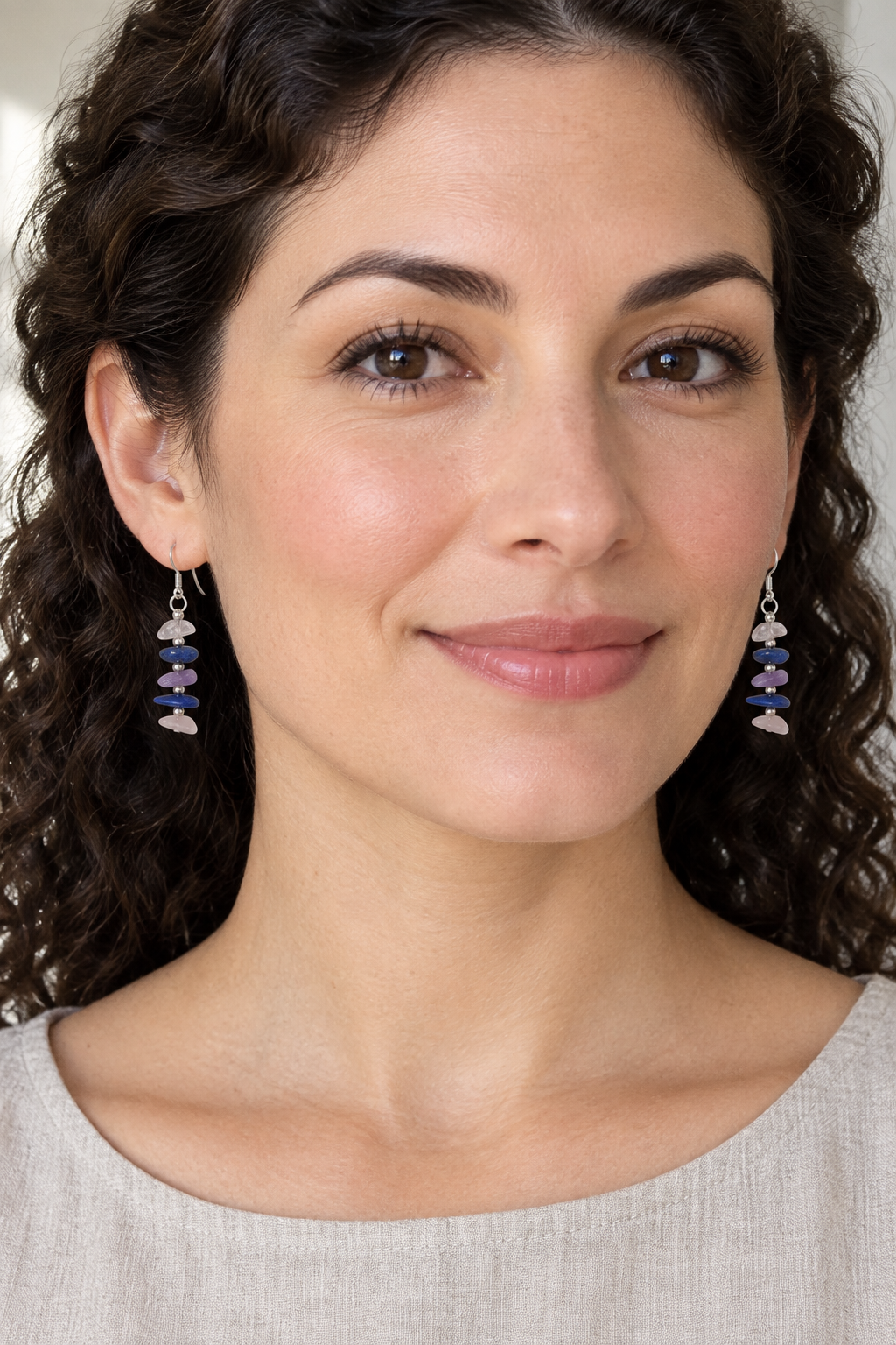 Shorter earrings on model with curly hair