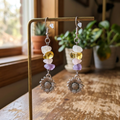 Sunflower earrings on a sunlit jewelry stand