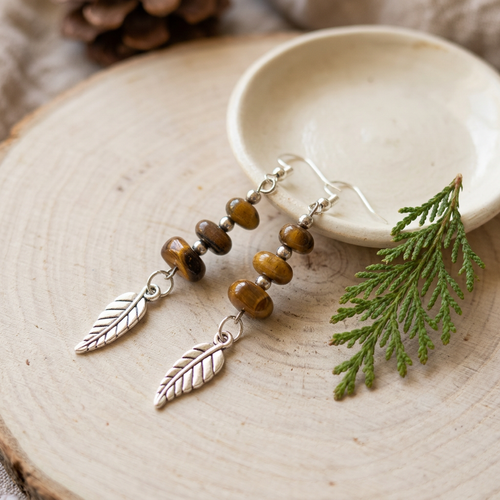 Woodland Feathers earrings styled on natural wood